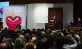 The Sotheby`s auctioneer looks for bids on the Jeff Koons - Hanging Heart